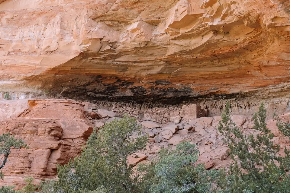 Stone cliff dwelling in a red rock alcove in Boynton Canyon