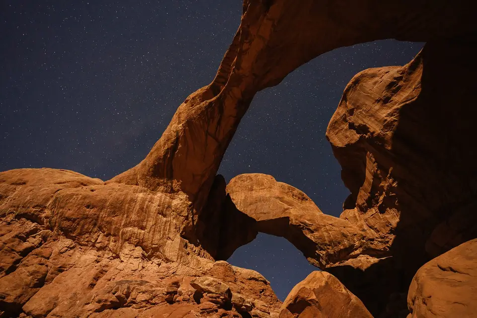 Double Arch at night under stars in Moab, Utah
