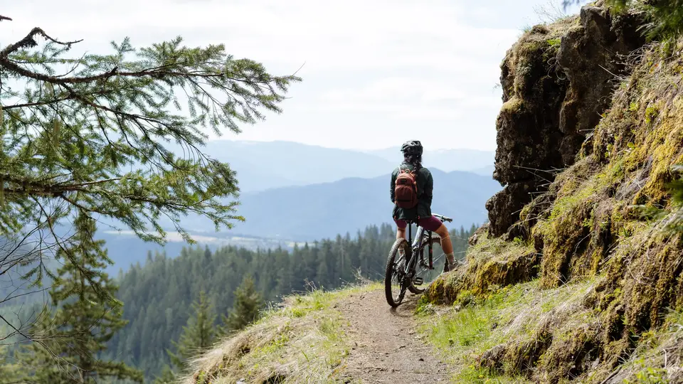 Melanny looking at distant mountain off a mountain bike trail in Oakridge, Oregon