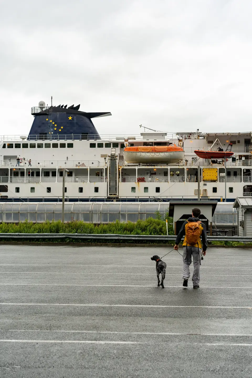 Evan and Penelope (Dog) walking in the port parking lot waiting to board the MV Kennicott in Juneau, Alaska