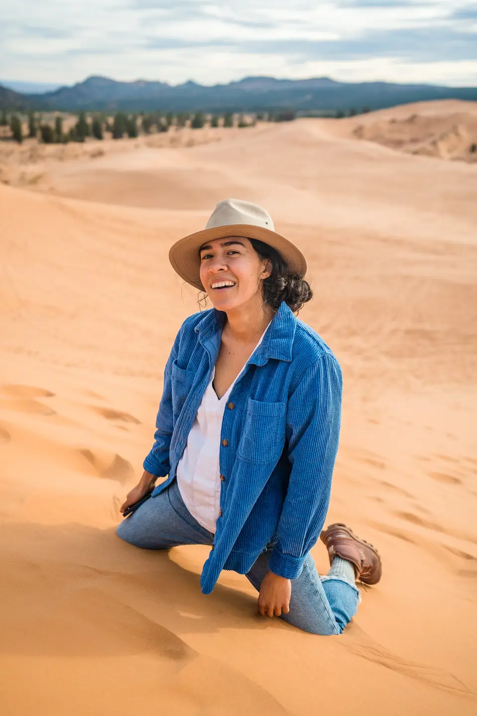 Person sitting in the sand at Coral Pink Sand Dunes State Park