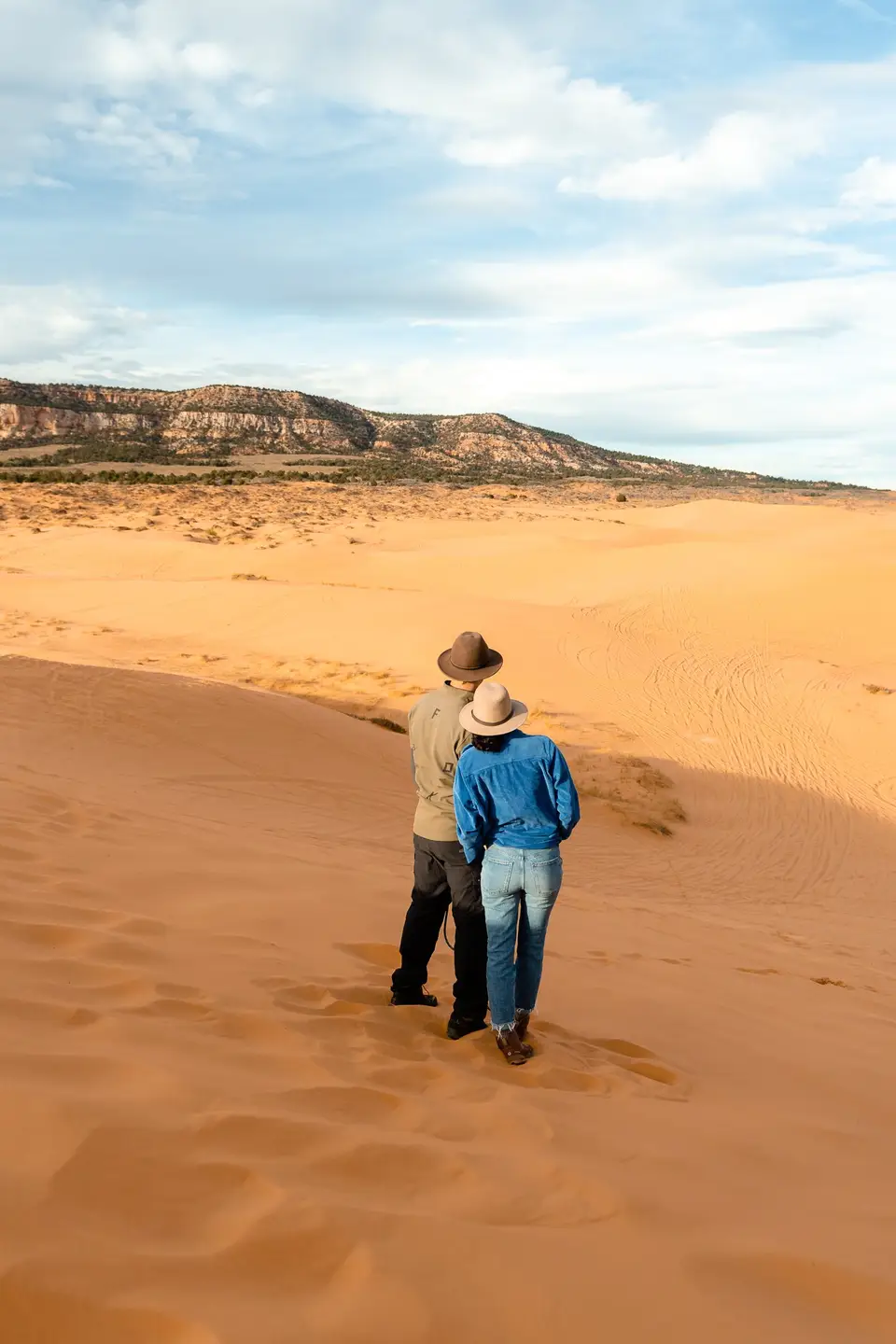 Evan and Melanny in hats looking out over the Coral Pink Sand Dunes