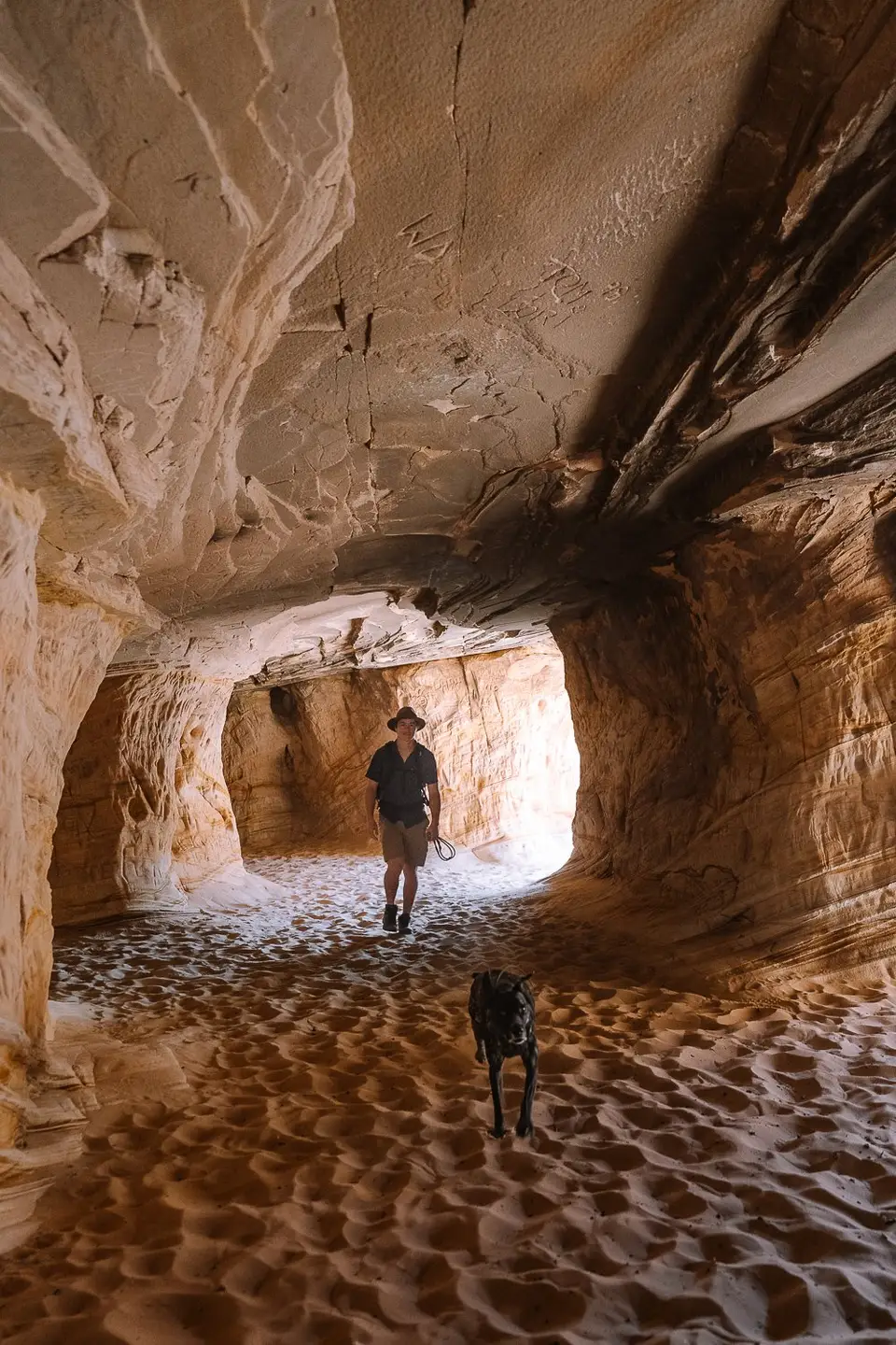 Evan and dog running through the Moqui Sand Caves