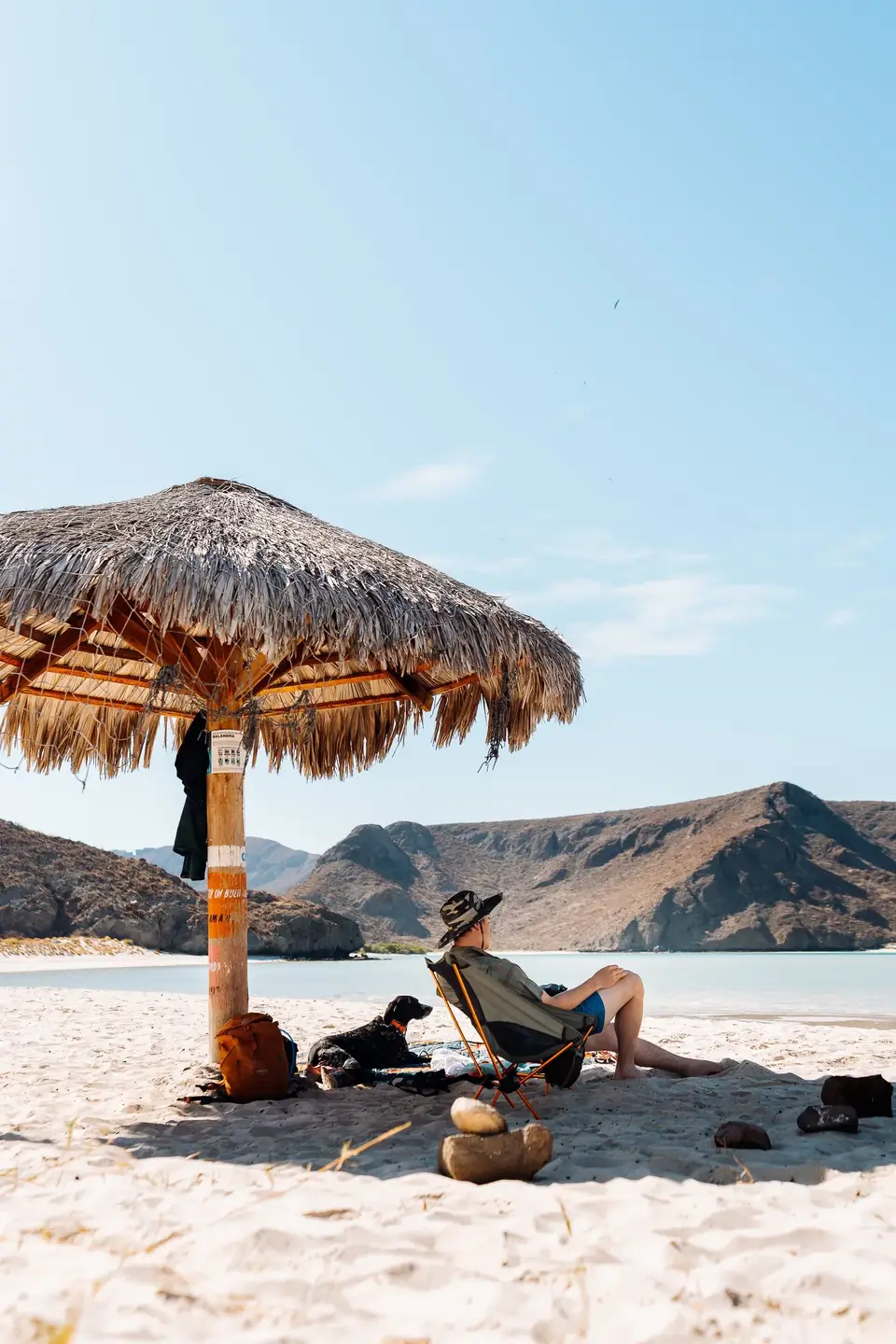 A palapa on the sand, a camp chair and Penelope in the shade near La Paz, Baja California Sur