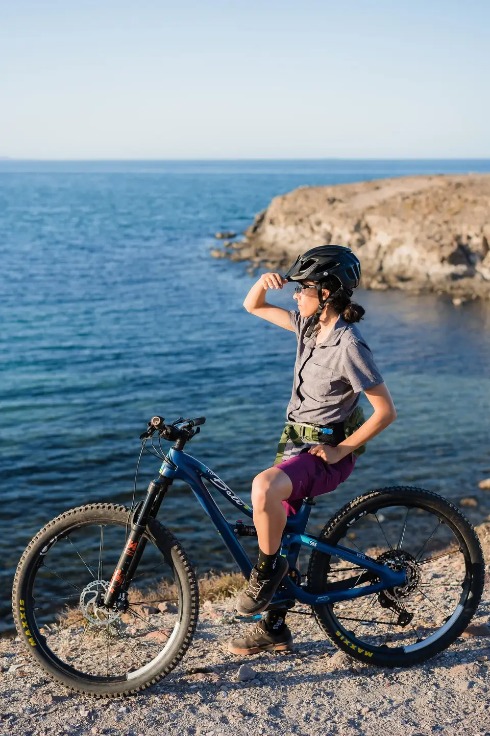 A mountain biker stopped on a coastal trail above the sea near Mulegé, Baja California Sur
