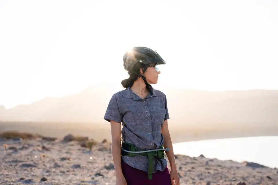 A rider in a helmet on a high ridge above a misty valley near Mulegé, Baja California Sur