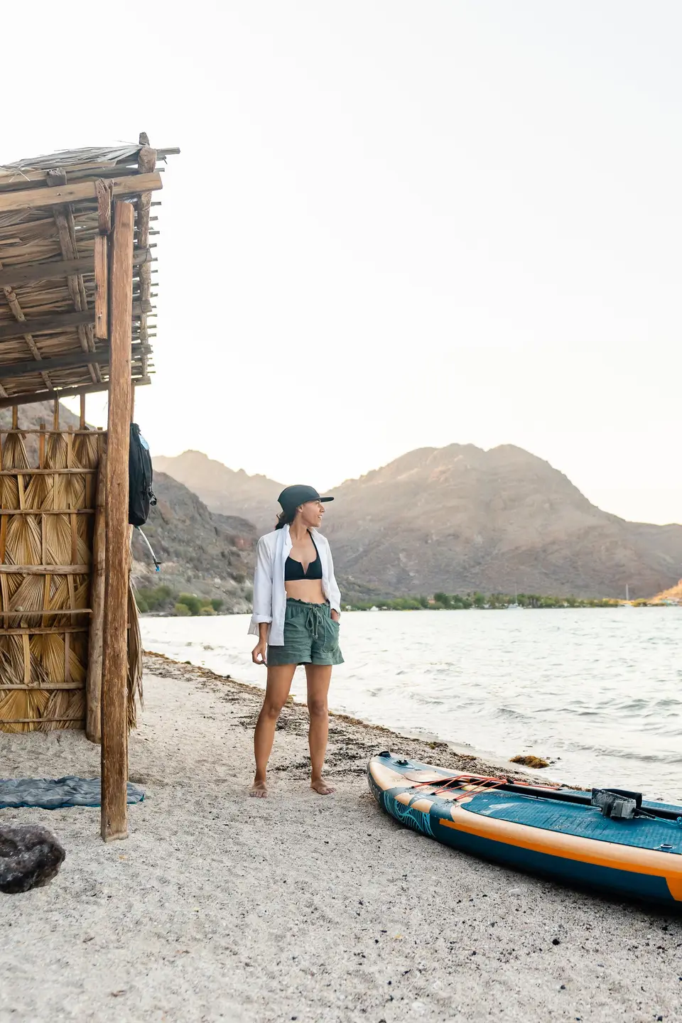 Melanny on the sand beside a thatched beach hut in Bahía de Concepción, Baja California Sur