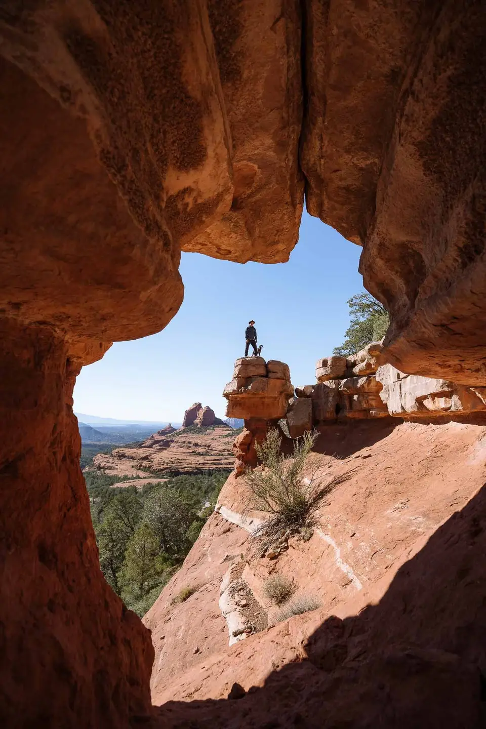 Looking out of Merry-Go-Round cave at Evan and Penelope standing on the rock stack