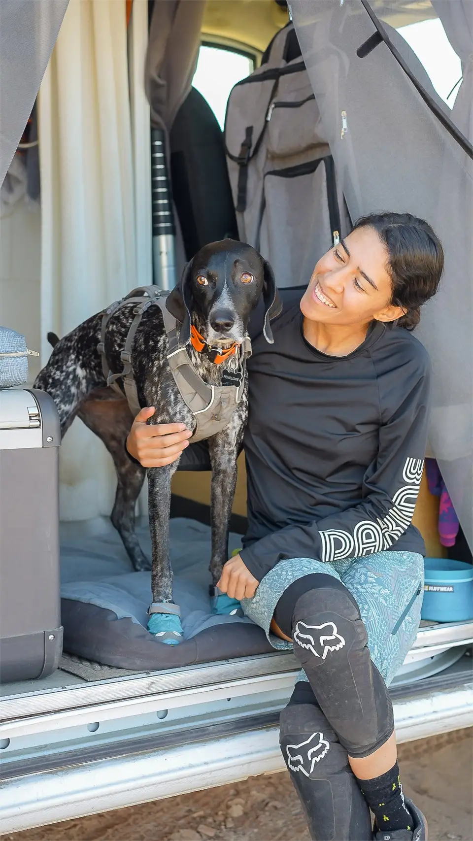 Melanny and Penelope in the back of the van in Ruffwear gear